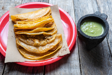 Mexican food: Tasty basket tacos "canasta" on wooden background