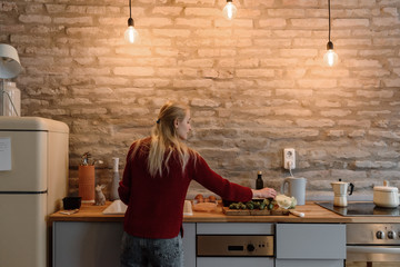 Woman cooking at counter in cozy kitchen