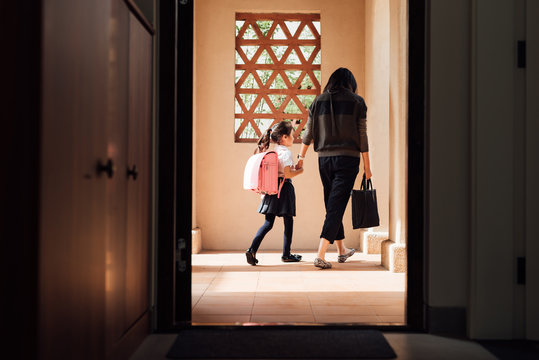 Mother taking her kid to school in the morning