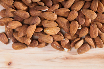 Roasted almonds on wooden background