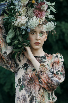 Model in dress with floral headwear