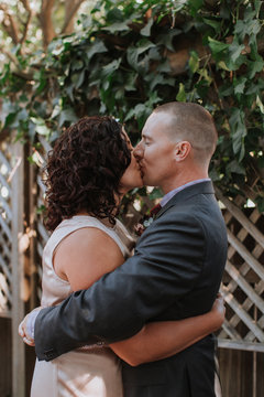 Wedding Couple Embracing and Kissing