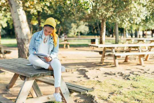 Muslim woman studying in the park