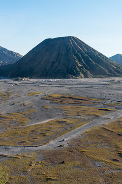 Red car crossing the lava sea of Mount Bromo