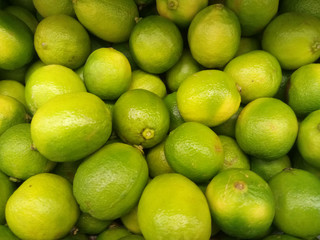 fresh green lime fruits on the market in a box