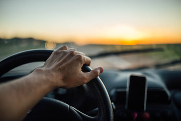 car driver travels in the summer at sunset. concept car trip
