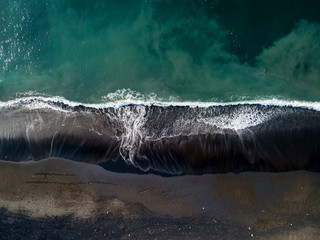 Drone views of black beach in Bali