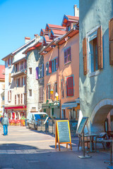 Fototapeta na wymiar Old narrow street in Annecy, France. Medieval bright buildings in sunny summer day. 