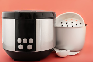 Modern multi cooker on color background