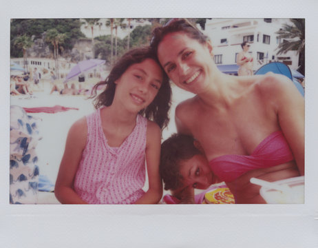 Happy mother with her children on the beach.