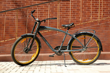 Modern bicycle parked near building