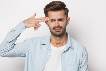 Guy puts fingers aimed to head like gun killing himself