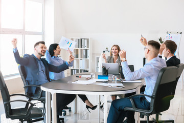 Team of happy business people during meeting in office