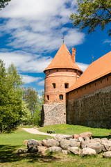 Trakai Island Castle in Lithuania, Eastern Europe. Tourists visit city castle. Famous ancient landmark