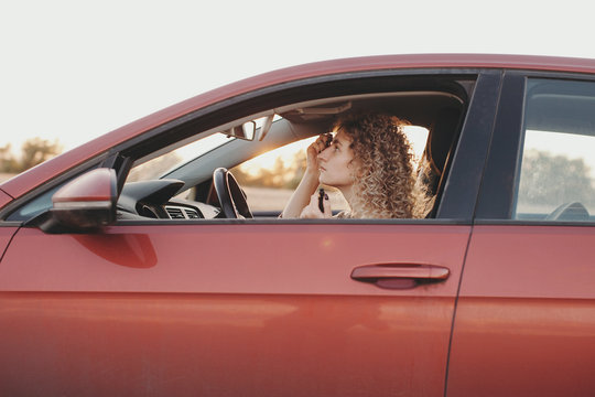 Woman driver applying makeup