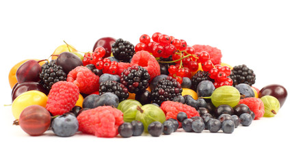 lots of fresh different berries on a white background