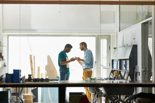 Teacher And Student Discussing Over Equipment