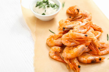 Tasty shrimps with sauce on white table