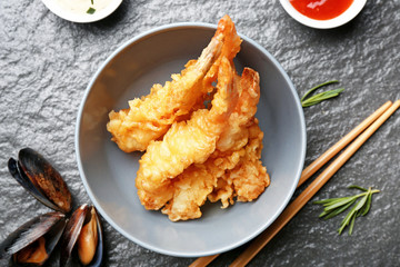 Bowl with tasty shrimps on table