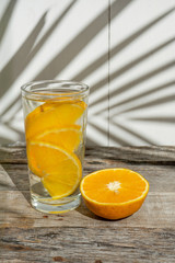 orange water with fresh fruit on wooden  background