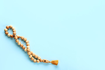 Muslim beads on color background