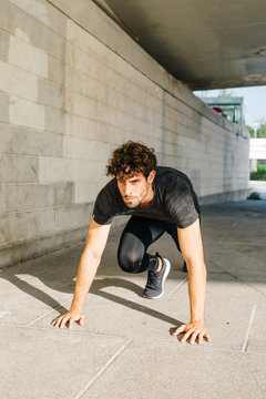 Athlete on crouch start on street