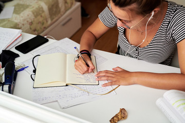 Woman writing notes in her diary.