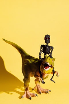 Skeleton riding green dinosaur
