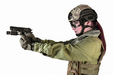 Fototapeta premium Beautiful fully equipped military soldier woman aiming at the enemy with pistol, isolated photo.