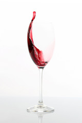 red wine poured from a glass. tableware for drinks.