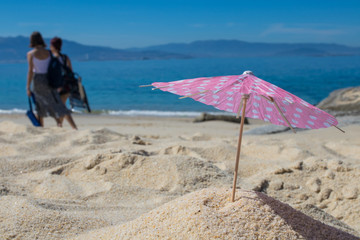 parasol in the sand of the beach, summer and holidays