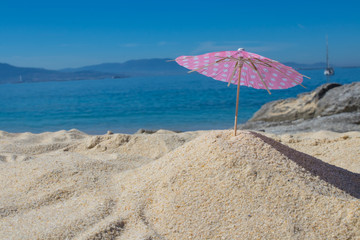 parasol in the sand of the beach, summer and holidays