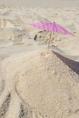 Fototapeta na wymiar parasol in the sand of the beach, summer and holidays