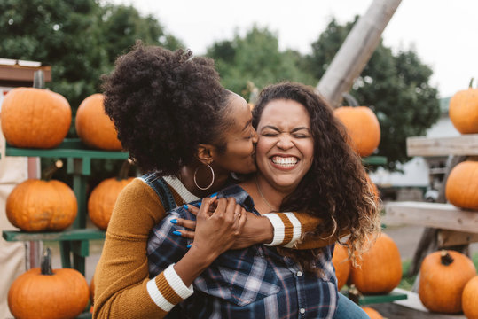 Two friend at a pumpkin patch at halloween