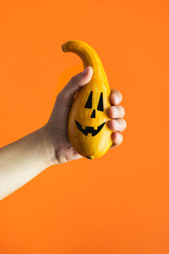 Halloween Cute Pumpkin in hand, Orange Background