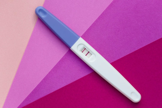 Positive pregnancy test on a gradient background