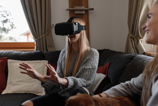 Excited woman touching air in VR headset