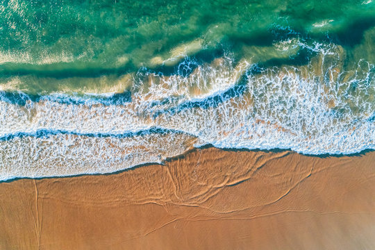 Aerial view of a wild beach at sunset