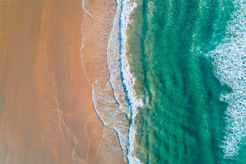 Obraz premium Aerial view of a wild beach at sunset