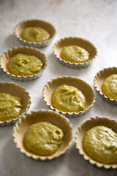 Tart shells with short crust pastry filled with pistachio frangipane