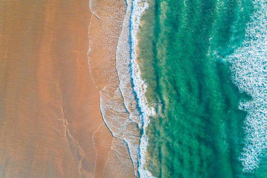 Aerial view of a wild beach at sunset