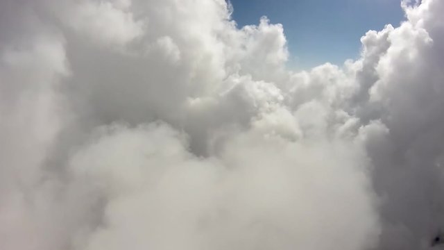 POV Flying Through Cloud Tunnel With Sun At The End.