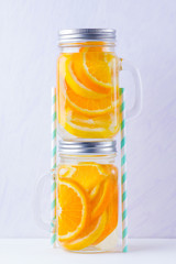 Infused water with fruits on white background. Mug delicious refreshing drink of mix fruits on white background. Iced summer drink in mason jar. Minimalism