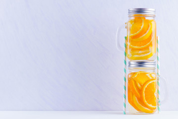 Infused water with fruits on white background. Mug delicious refreshing drink of mix fruits on white background. Iced summer drink in mason jar. Minimalism