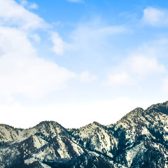 Square frame View of a striking mountain dusted with snow on a sunny day