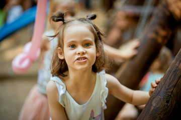 Fototapeta na wymiar Portrait of cute little girl at playground on summer day