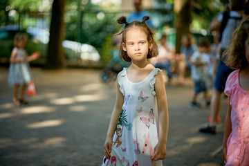 Portrait of cute little girl at playground on summer day