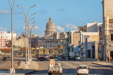 Road full of cars in the center of Havana with Capitol in the background, Cuba
