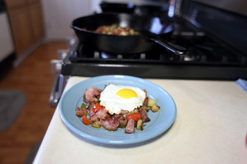 Plate of corned beef hash with a fried egg sunny side up.