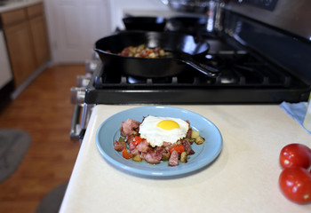 Plate of corned beef hash with a fried egg sunny side up.